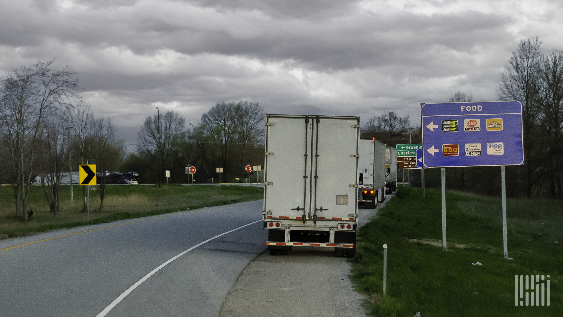 Trucks parked along exit ramp.