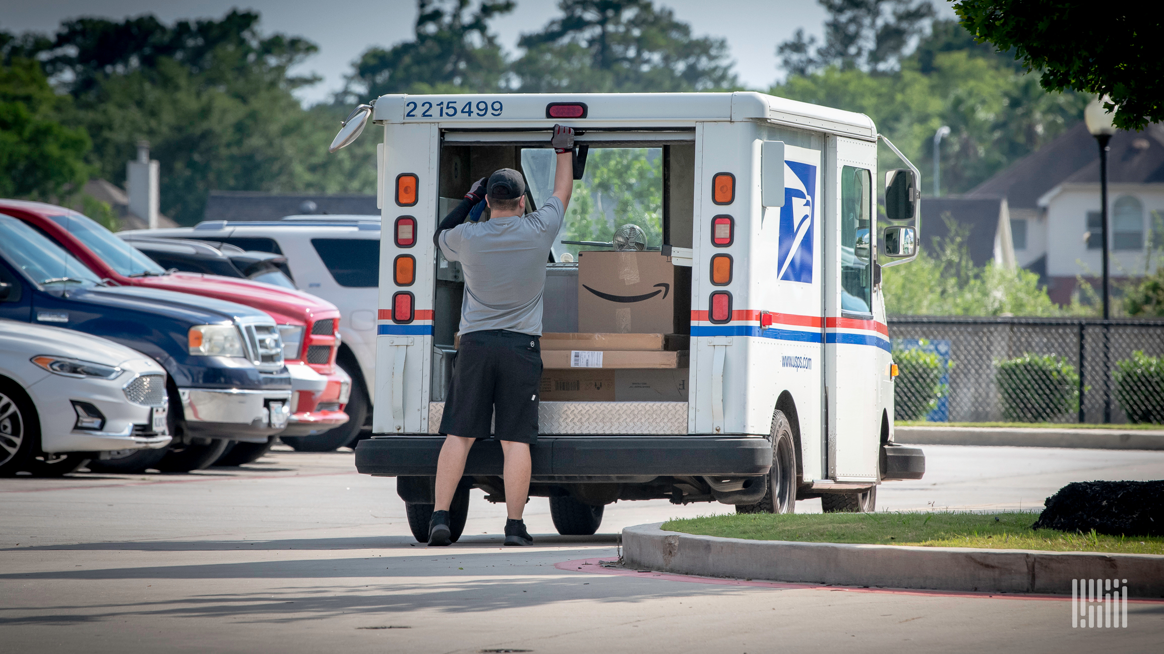 Mailman pulling boxes out of truck