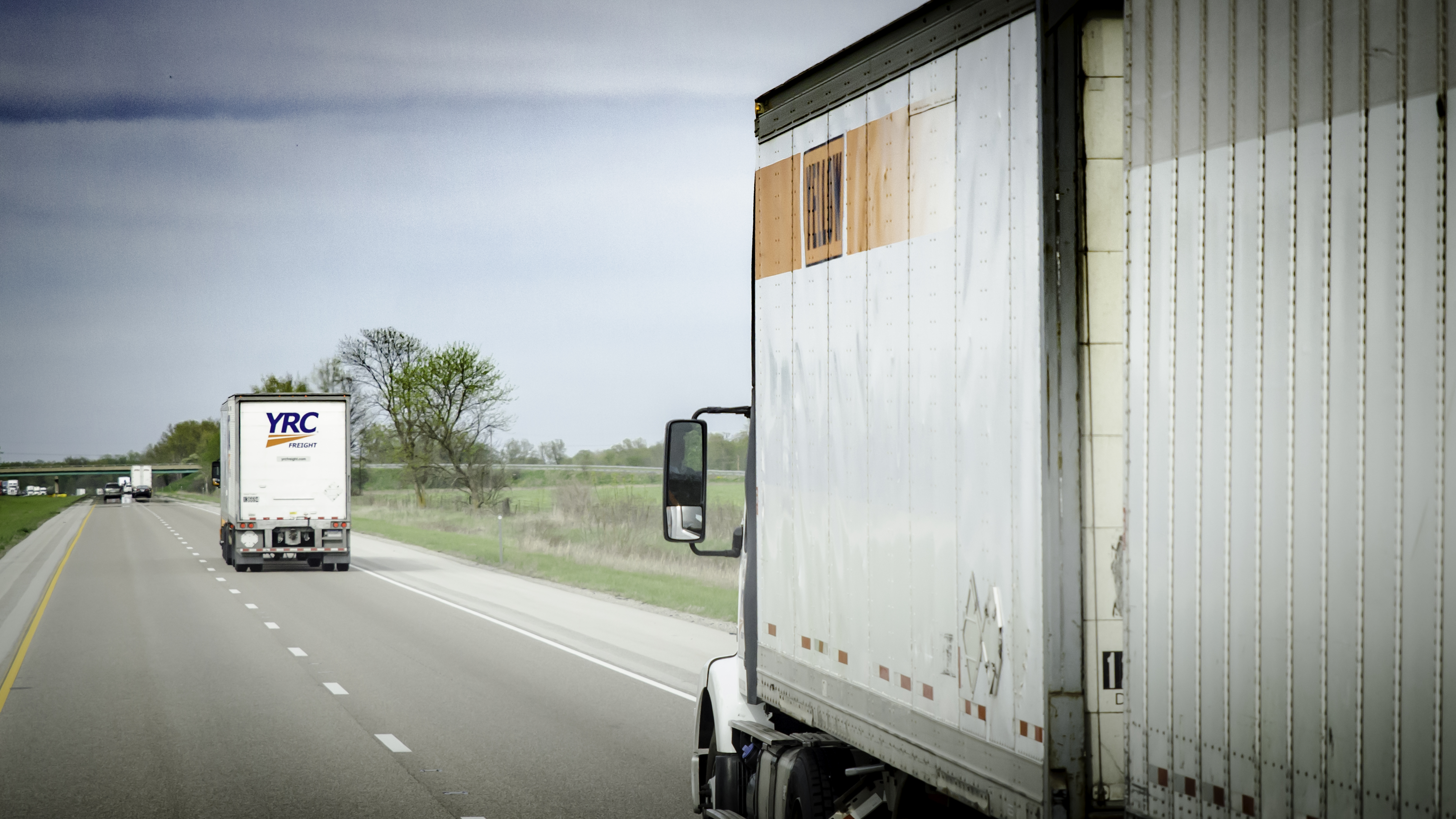 Two YRC trucks on the highway