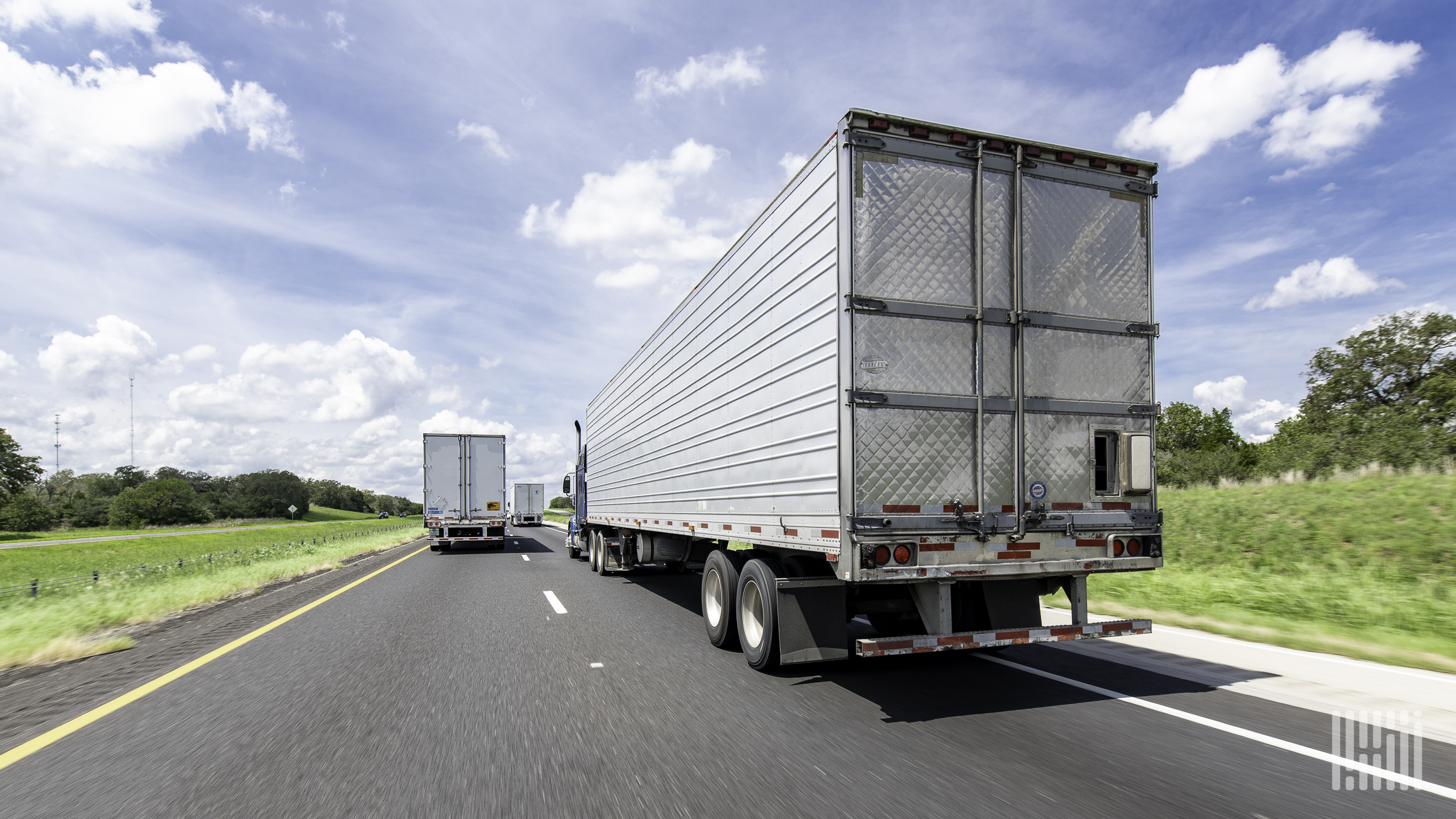 A rearview of tractor-trailers on highway