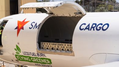 Close of a cargo aircraft with the side cargo door raised.