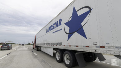 A Landstar trailer being pulled by a carrier on the highway