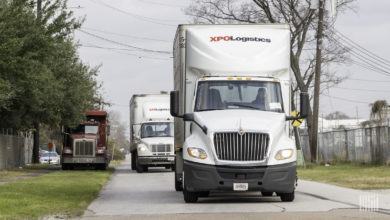Two XPO trucks on the road