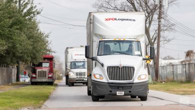 Two XPO trucks on the road