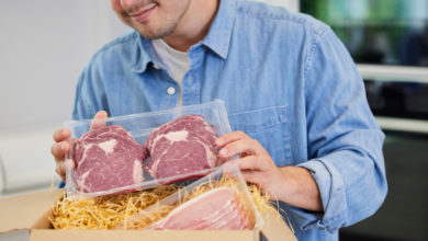 Man unpacks box of meat