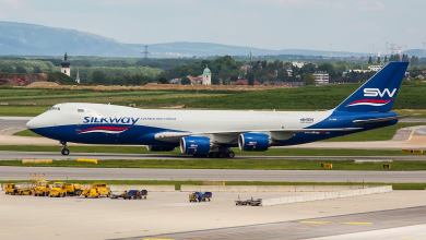 A white and blue Silk Way West Airlines jet at an airport.