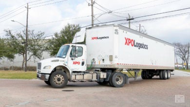 A white XPO tractor and trailer