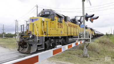 A freight train passes by a railroad crossing.