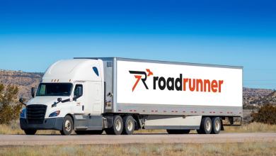 A white Roadrunner tractor-trailer on the highway