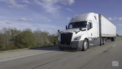 A white tractor-trailer on highway