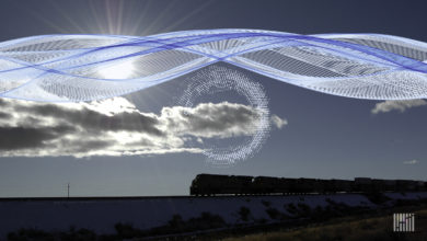 A train drives on the horizon. A computerized image of a cloud is above the train.