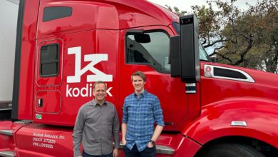 Kodiak executives in front of red truck