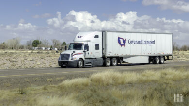 A white Covenant tractor-trailer on highway