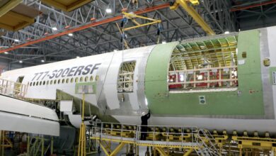 A side view of an aircraft fuselage cut open during a rebuild for cargo.