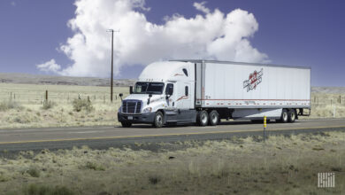 A white Heartland Express tractor-trailer on the highway