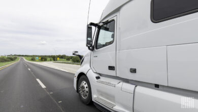 A white sleeper cab on the highway