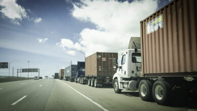 Trucks with chassis and containers lined up to enter Port of Los Angeles