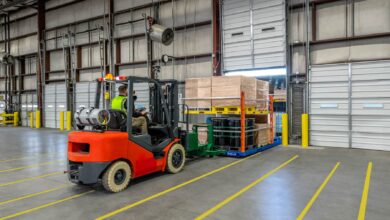 A forklift unloading a Vaux mobile platform inside a warehouse