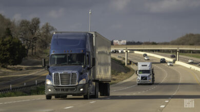 A blue tractor-trailer on a highway