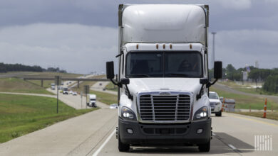 Front view of a white tractor-trailer on a highway