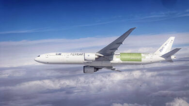 A large jetliner with a patch on its airframe undergoes a test flight , as seen above the clouds.