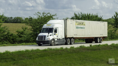 A tractor pulling a J.B. Hunt Intermodal container on a highway