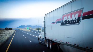 A white Pam Transportation tractor-trailer on the highway