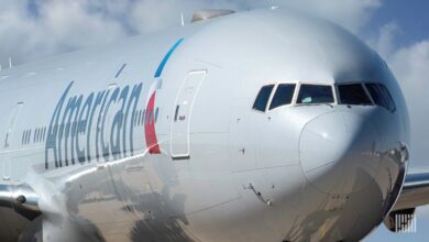 Close up facing nose of gray American Airlines jet.