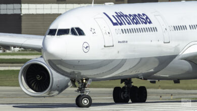 Close up of white Lufthansa jet, front view.