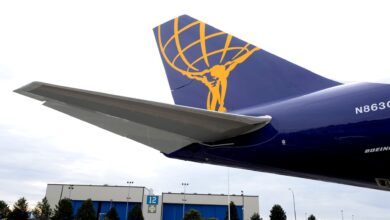 Close up of royal blue aircraft tail with gold Atlas Air logo