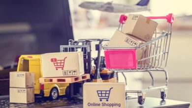 Toy shopping cart, van, boxes and forklift depicting e-commerce packages moving in trade.