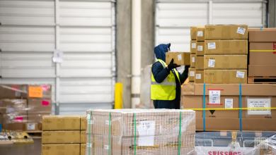 A worker moving packages in cold storage facility