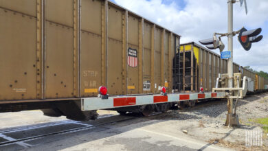 A train passes by a railroad crossing.