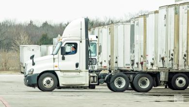 Driver in a truck backing up to a trailer