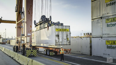 J.B. Hunt intermodal containers being lifted at a port