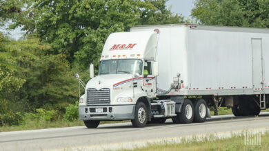 A white M&M Transport rig on the road