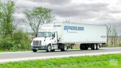 A white Express 2000 truck on the highway