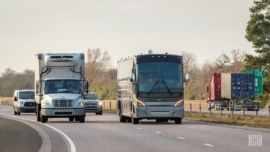 A Freightliner M2 on the left side of the image was among the vehicles included in a Dana Inc. recall.