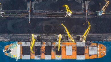 a photo of coal being loaded on a dry bulk ship