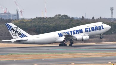 A white jumbo jet with blue "Western Global" lettering takes off.