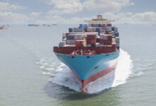 A loaded container ship nearing a port