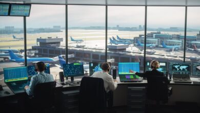 View of the inside of an air traffic control center looking through the glass to the airfield.
