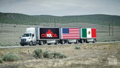 A tractor pulling three LTL trailers with Canada, U.S. and Mexico branding