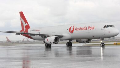 A red-tailed Qantas Freight plane with Australia Post logo.