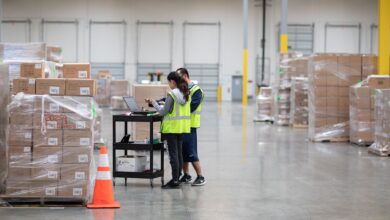 Workers with yellow vests in a warehouse.