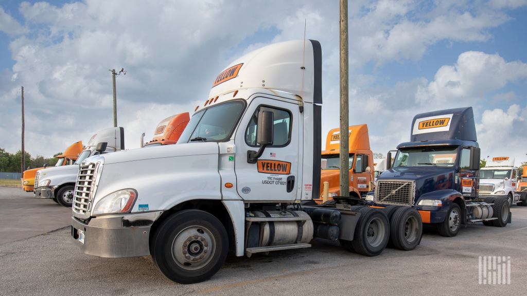 Yellow trucks parked at a terminal