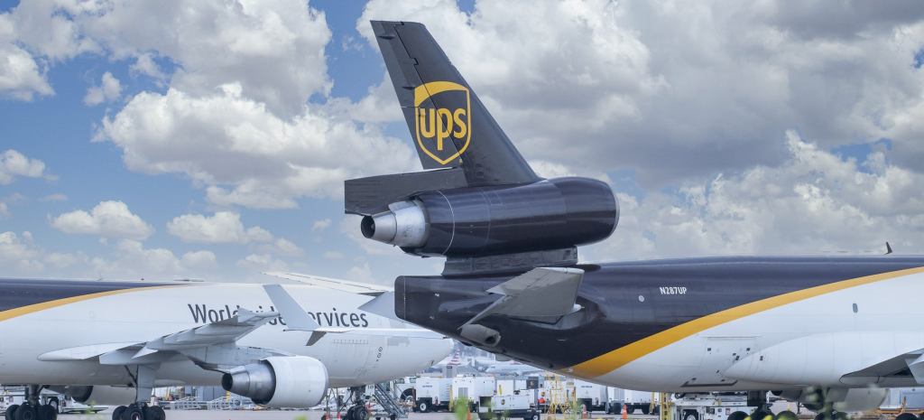 Close up of a brown-tailed UPS freighter with a rear engine on the ground.