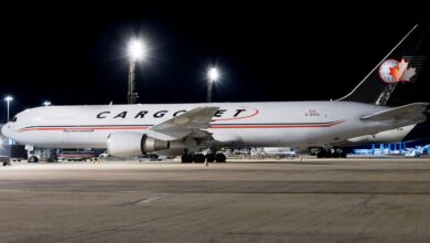 A large Cargojet plane on the tarmac at night.