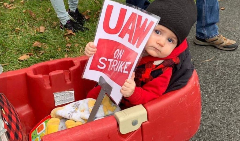 Infant with strike sign in wagon