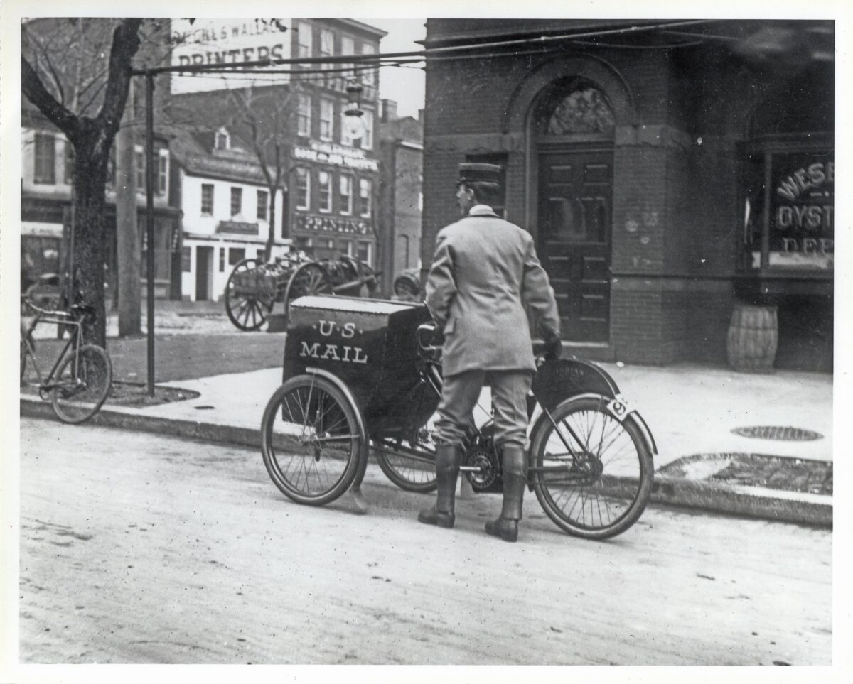 Three wheeled 1912 Indian bike vintage handing over mail postal service